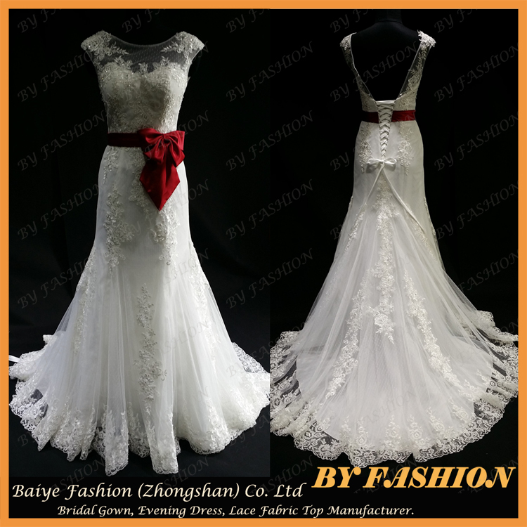 wedding dress with large red ribbon